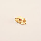 Kleine lipbroche met granaat